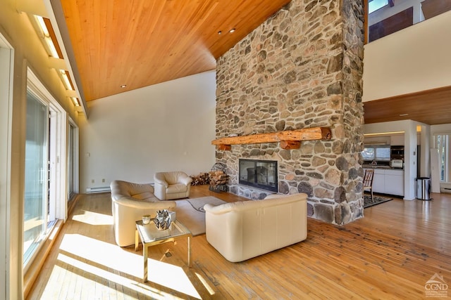 living room featuring a stone fireplace, high vaulted ceiling, and hardwood / wood-style flooring