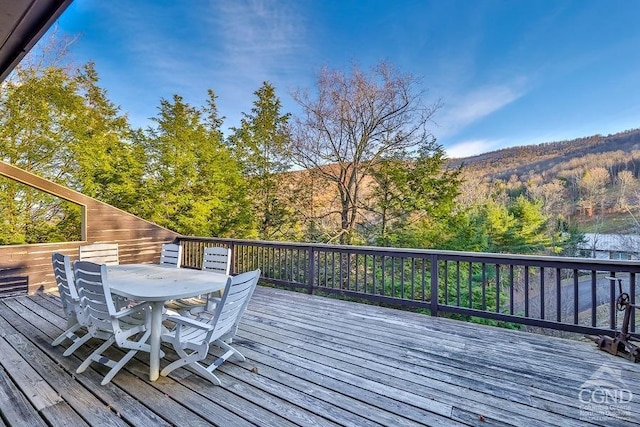 wooden deck featuring a mountain view