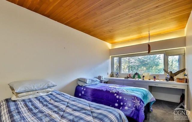 carpeted bedroom with wooden ceiling