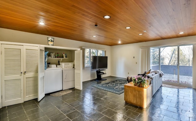 living room featuring washer and clothes dryer and wooden ceiling