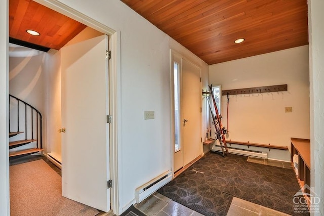 interior space featuring dark colored carpet, a baseboard radiator, and wood ceiling