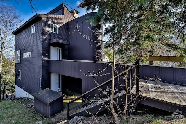 rear view of property featuring a deck