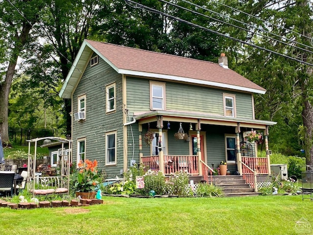 view of front of home with cooling unit, a front lawn, and covered porch