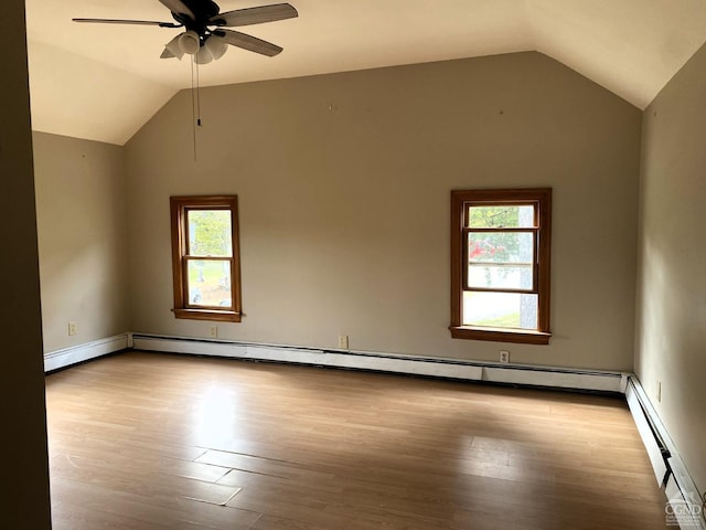 spare room with plenty of natural light, ceiling fan, baseboard heating, and light hardwood / wood-style flooring