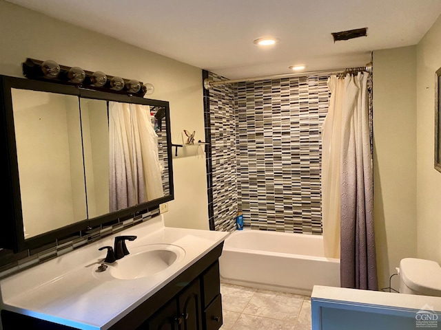 full bathroom with tile patterned flooring, vanity, toilet, and shower / bath combo with shower curtain