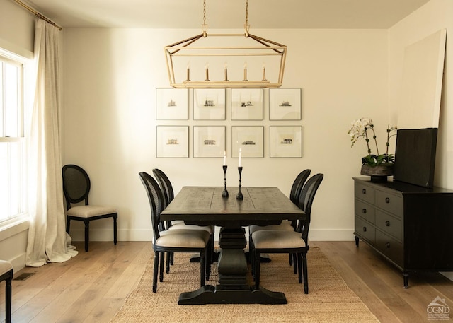 dining space with light hardwood / wood-style flooring