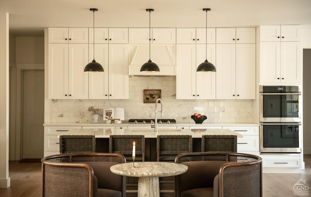 kitchen featuring white cabinets, stainless steel appliances, and pendant lighting