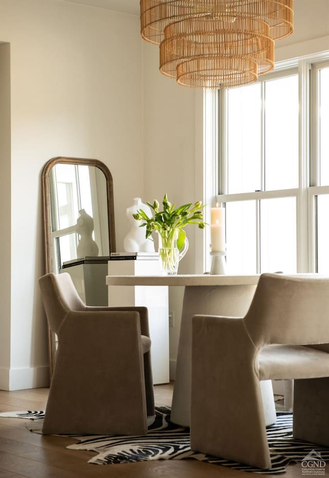 unfurnished dining area with a notable chandelier and hardwood / wood-style floors