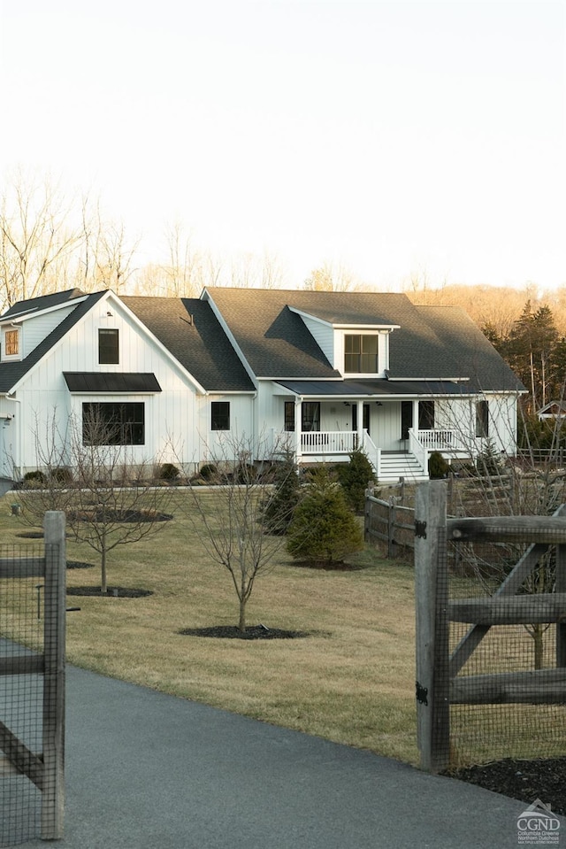 view of front of home featuring covered porch and a front lawn