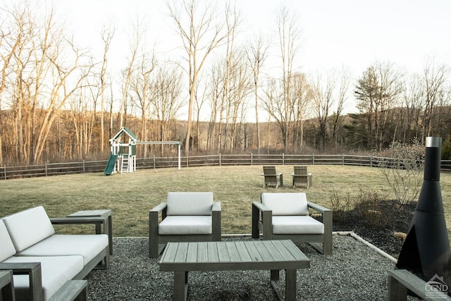 view of yard with an outdoor living space and a playground