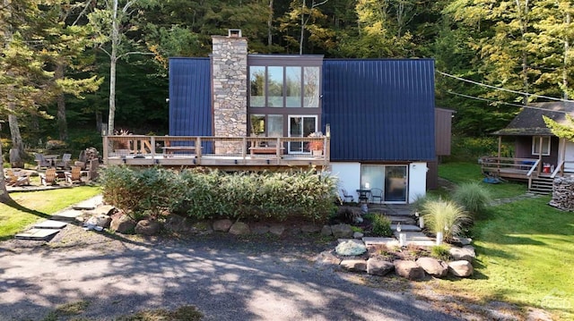 rear view of house featuring a deck