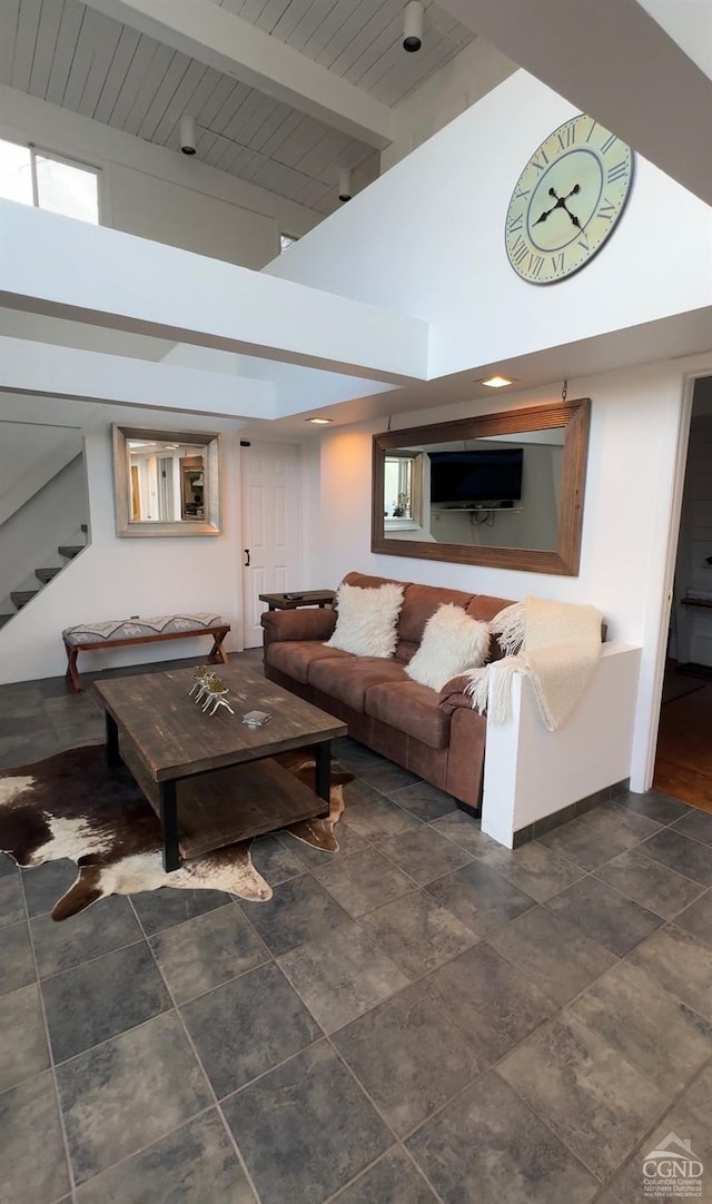 living room featuring a towering ceiling and wood ceiling