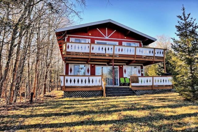 rear view of house featuring a lawn