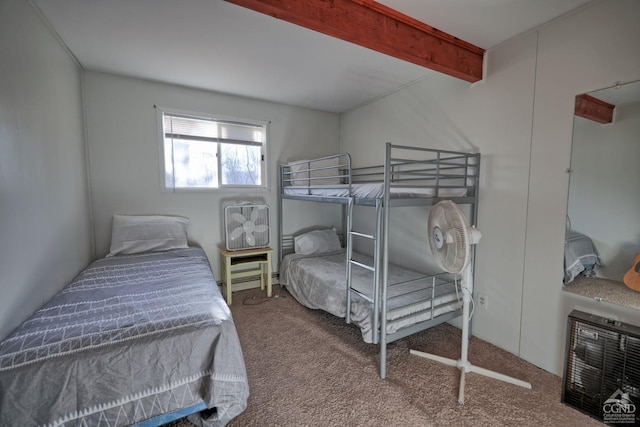 carpeted bedroom featuring beamed ceiling