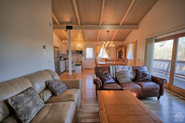 living room featuring light hardwood / wood-style floors, plenty of natural light, and a notable chandelier