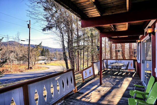 wooden deck featuring a mountain view and a porch