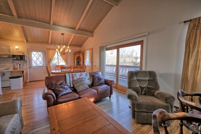 living room featuring plenty of natural light, beamed ceiling, a chandelier, and light wood-type flooring