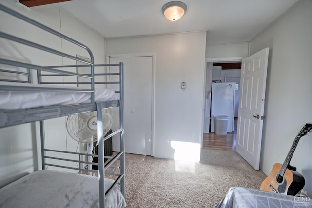 bedroom featuring white refrigerator and wood-type flooring