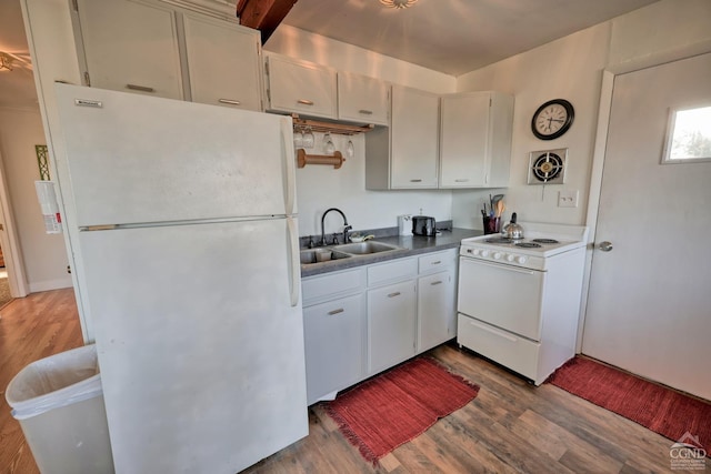 kitchen with hardwood / wood-style flooring, white cabinetry, white appliances, and sink