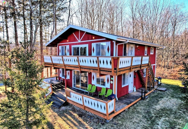 back of house featuring a wooden deck