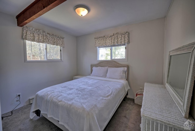 carpeted bedroom with beamed ceiling and multiple windows