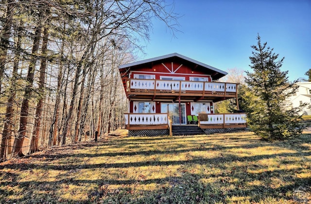 view of front of property with a front lawn and a wooden deck