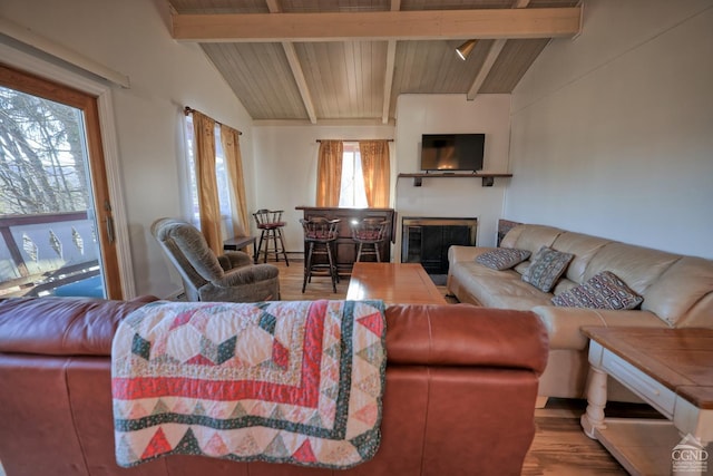 living room with wood ceiling, hardwood / wood-style floors, and lofted ceiling with beams