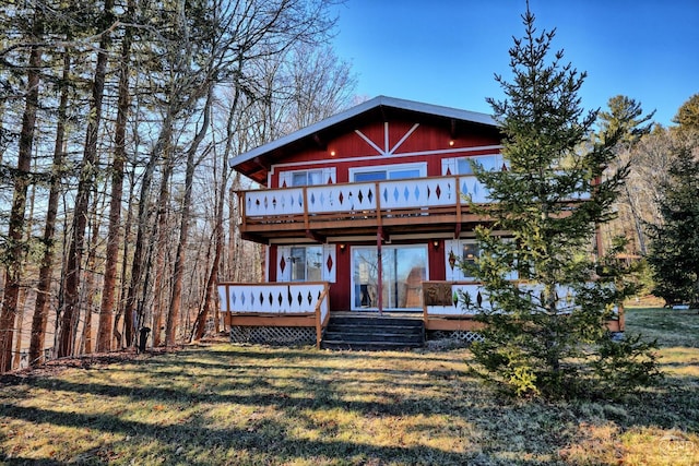 view of front of house with a deck and a front yard