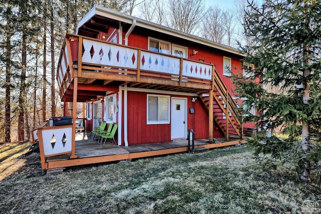 rear view of property with a wooden deck