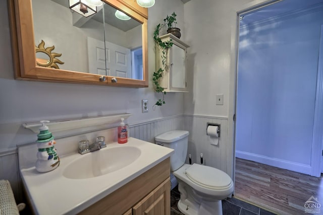 bathroom with hardwood / wood-style floors, vanity, and toilet