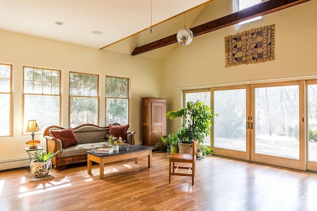 living area featuring plenty of natural light, light wood-style flooring, high vaulted ceiling, and beamed ceiling