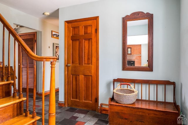 staircase with stone finish flooring and baseboards