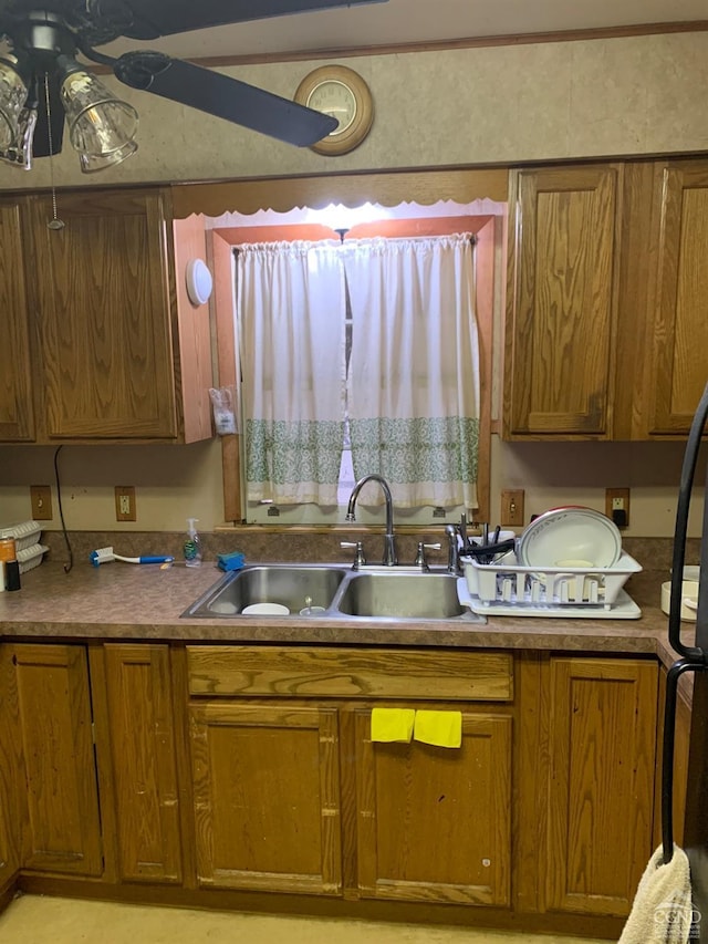 kitchen featuring ceiling fan and sink