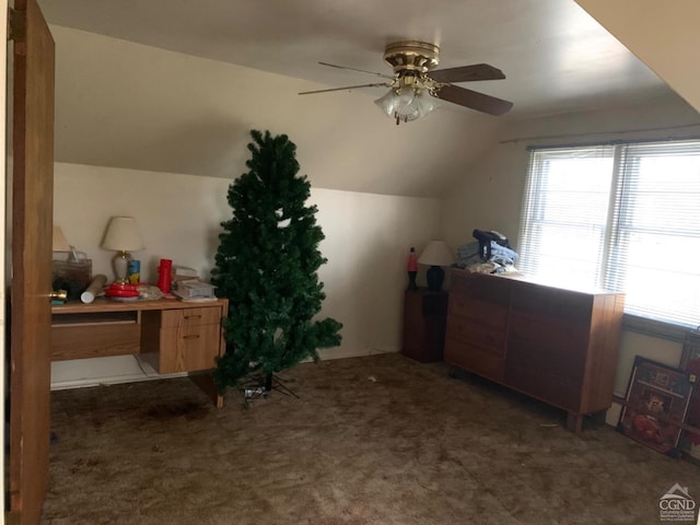 additional living space with dark carpet, ceiling fan, and lofted ceiling