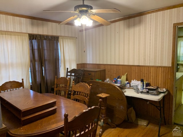 dining space with hardwood / wood-style floors, ceiling fan, and ornamental molding