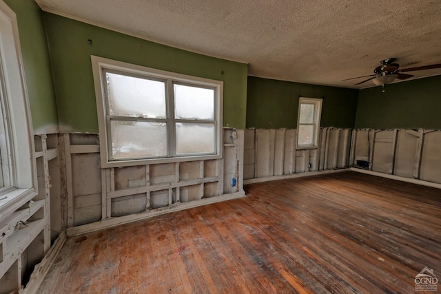 miscellaneous room with a textured ceiling, ceiling fan, and dark wood-type flooring