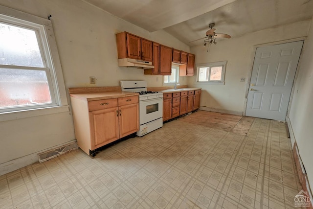 kitchen with white gas range, ceiling fan, sink, and lofted ceiling