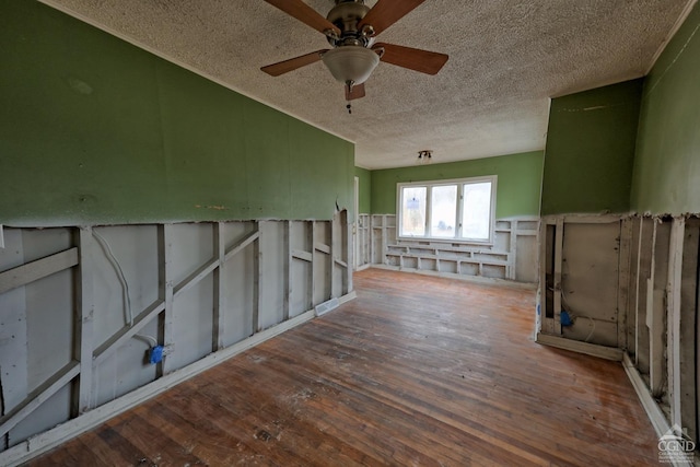 unfurnished room featuring ceiling fan, a textured ceiling, and hardwood / wood-style flooring