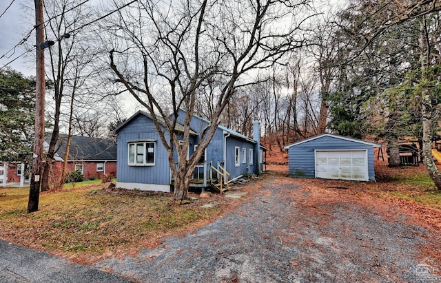 view of front of home with a garage and an outdoor structure