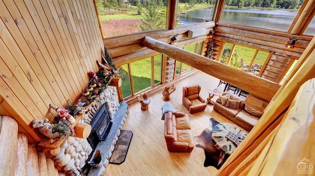 sunroom with a water view and a fireplace