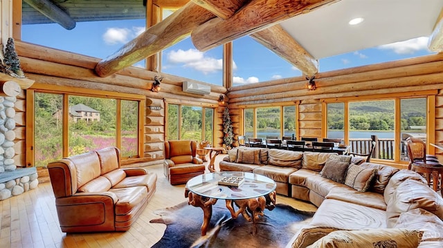 sunroom / solarium with plenty of natural light, beam ceiling, and an AC wall unit