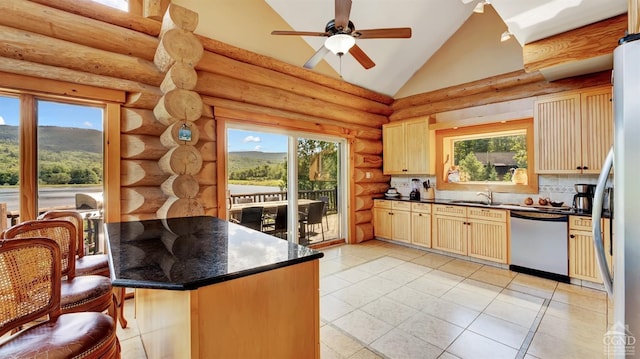 kitchen featuring a kitchen bar, a healthy amount of sunlight, log walls, and stainless steel appliances