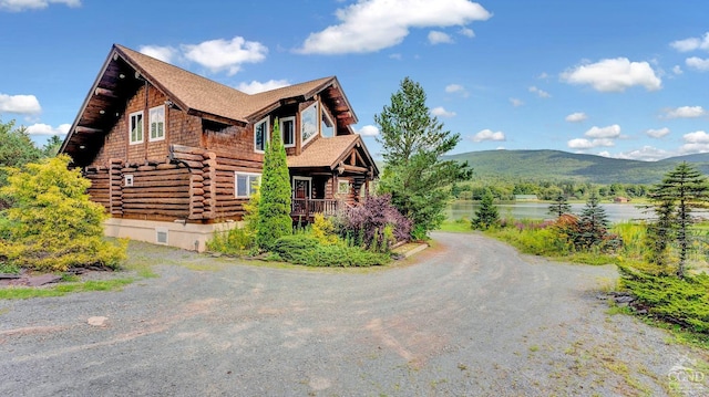 view of property exterior featuring a water and mountain view