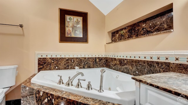 bathroom featuring tiled tub, lofted ceiling, and toilet