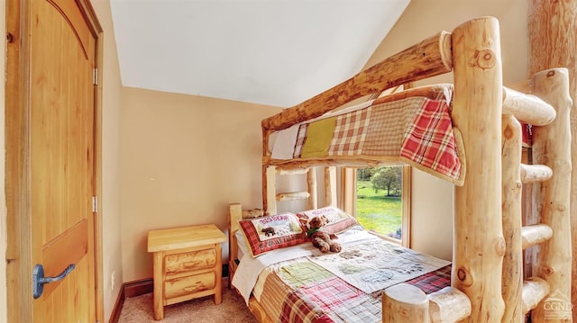 bedroom with carpet floors and vaulted ceiling