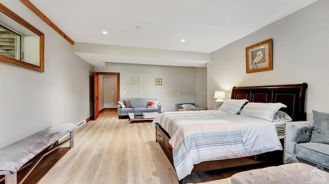 bedroom featuring light hardwood / wood-style flooring and crown molding