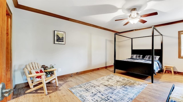 bedroom with light hardwood / wood-style flooring, ceiling fan, and crown molding