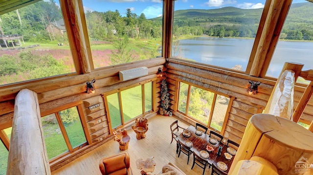 sunroom / solarium with a wealth of natural light and a water and mountain view