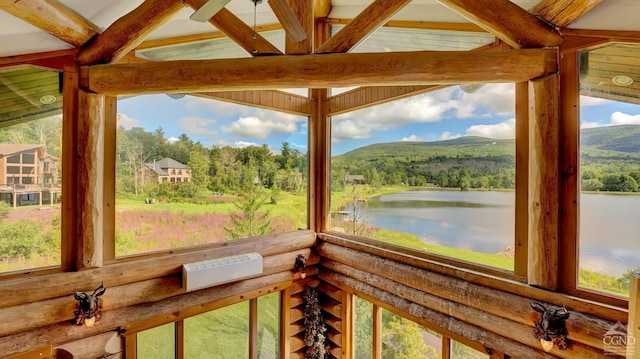 unfurnished sunroom with lofted ceiling with beams and a water and mountain view