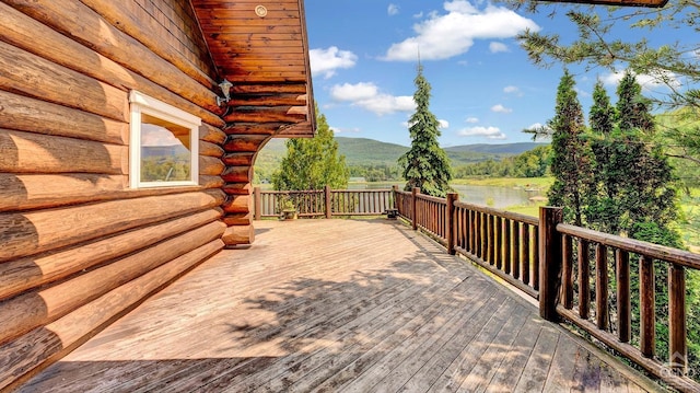 wooden terrace featuring a water and mountain view